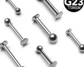 May include: Several silver-coloured barbell body jewellery pieces. Each has a straight bar with a ball at one end and a flat disc at the other. The image includes a black and white circle with the text "SOLID G23 TITANIUM".