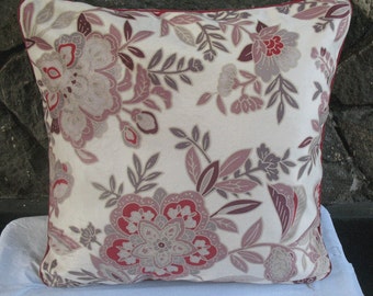 cream throw pillow with floral design