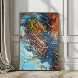 May include: Abstract art print with a gold frame. The artwork features a vibrant mix of colors, including blues, oranges, and gold, creating a dynamic and fluid composition. The painting's texture and color palette evoke a sense of movement and depth.