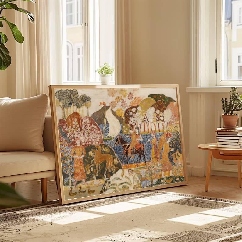 May include: A framed artwork with a colorful, detailed illustration. The artwork features figures, animals, and trees in a landscape. The frame is a light wood color, and the artwork is displayed in a well-lit room.