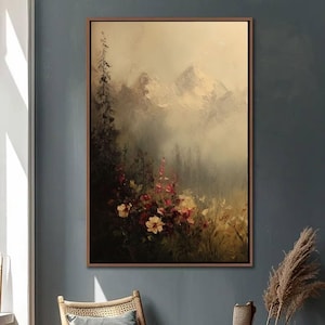 May include: An oil painting of a mountain landscape with a floral foreground. The artwork features a muted color palette with shades of beige, brown, and green. The flowers are a mix of red, pink, and yellow. The painting is framed in a brown wooden frame.