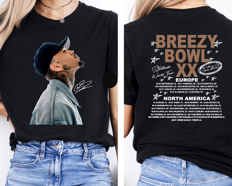 May include: Black t-shirt featuring a portrait of a man wearing a cap and denim jacket. The front of the shirt has a signature. The back of the shirt has the text "BREEZY BOWL XX Stadium World Tour" and a list of tour dates.