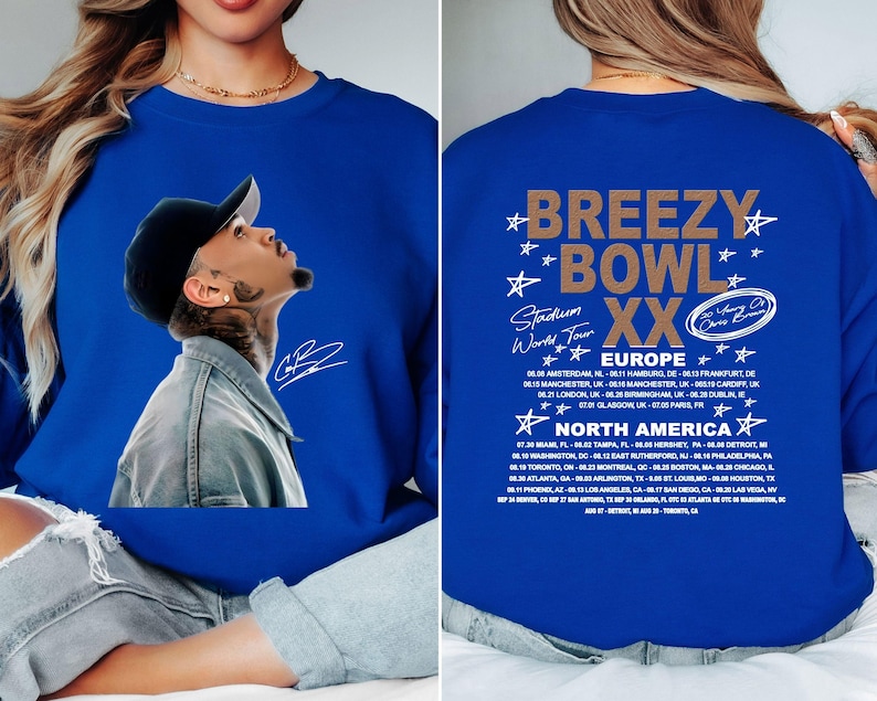 May include: Royal blue sweatshirt featuring a portrait of a man wearing a black cap, with a signature. The back of the sweatshirt displays the text "Breezy Bowl XX Stadium World Tour" with a list of European and North American tour dates.
