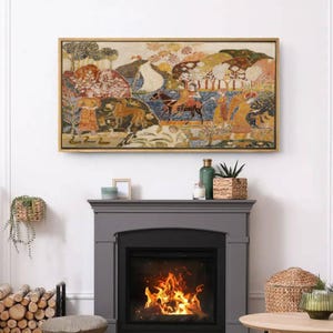 May include: A framed artwork with a gold-colored frame depicts a colorful, detailed scene with figures, animals, and trees. The artwork is mounted above a gray fireplace with a burning fire inside.