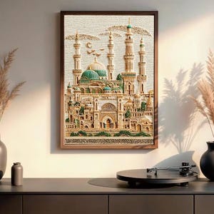 May include: A framed artwork depicting a detailed architectural scene with minarets and domes, in shades of beige, green, and gold. The artwork is displayed above a dark gray cabinet, with decorative vases and a record player.