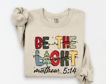 Be The Light Christmas Sweatshirt, Religious Christmas Shirt, Christmas Shirt for Women, Christmas Gift, Bible Verse Sweatshirt