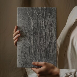 May include: A rectangular canvas print featuring a grayscale image of a dense thicket of trees and branches. The artwork is held by a person wearing a white shirt. The image has a textured appearance.