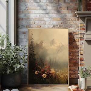 May include: A framed landscape painting featuring a mountain range in the background and a field of flowers in the foreground. The painting has a soft, muted color palette with shades of beige, green, and red. The artwork is displayed against a brick wall.