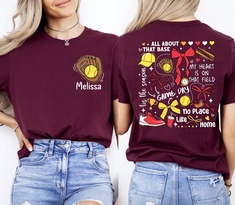 May include: Two maroon t-shirts with a softball theme. The front shirt has a baseball glove with a ball and the name "Melissa". The back shirt has a variety of softball-related graphics and the text "tis the season", "ALL ABOUT THAT BASE", "MY HEART IS ON THAT FIELD", "GAME DAY", "No Place Like Home".