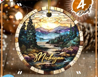 May include: A round ceramic ornament featuring a stained glass style landscape of a river flowing through a forest toward mountains. The word Michigan is written in gold script across the foreground. It hangs from a gold string.