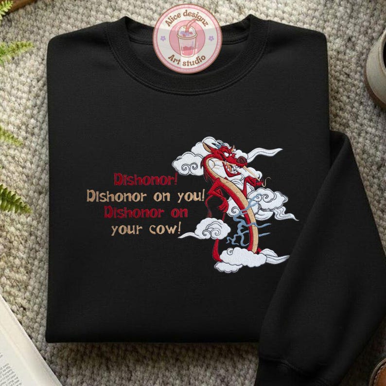 May include: Black sweatshirt featuring a red dragon design with white clouds and the text "Dishonor! Dishonor on you! Dishonor on your cow!". The sweatshirt has a crew neck and long sleeves. A circular logo is visible at the top.