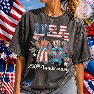 May include: A charcoal grey t-shirt featuring a graphic of Lilo and Stitch dressed in patriotic attire. The design includes the text USA and 250th Anniversary, surrounded by American flag motifs, fireworks, and stars in red, white, and blue colors.