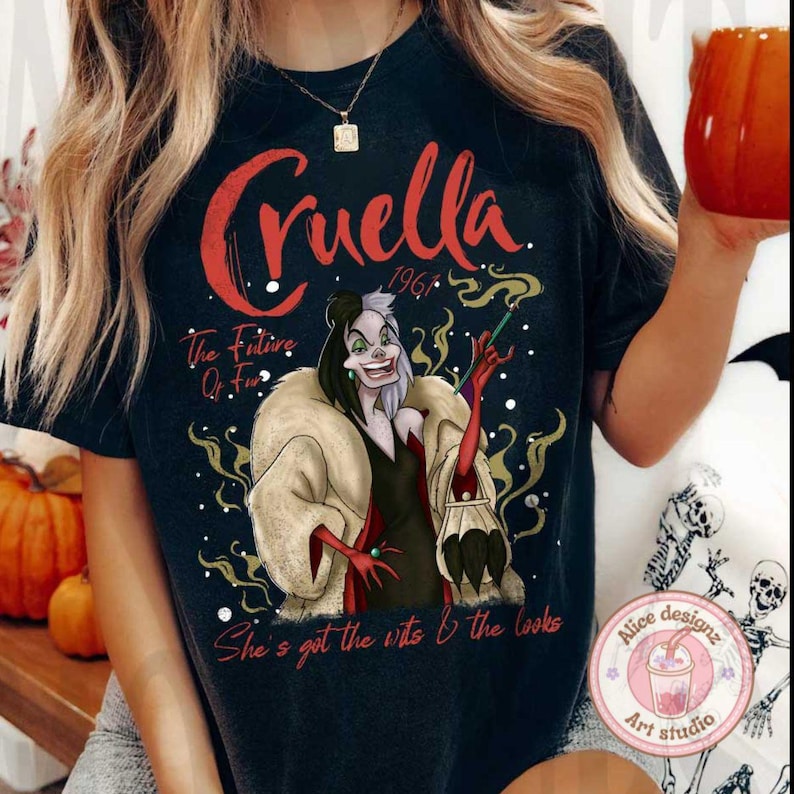 May include: Black t-shirt with a graphic of Cruella De Vil from the Disney movie 101 Dalmatians. The text "Cruella 1961" is above the image. The text "The Future Of Fur" is below the image. The text "She's got the wits & the looks" is at the bottom of the image.