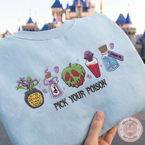 May include: Light blue sweatshirt with embroidered Halloween-themed graphics. Features a green apple skull, potion bottles, and the text "PICK YOUR POISON." The design includes a pot of flowers and the words "DEADLY NIGHT SHADE."