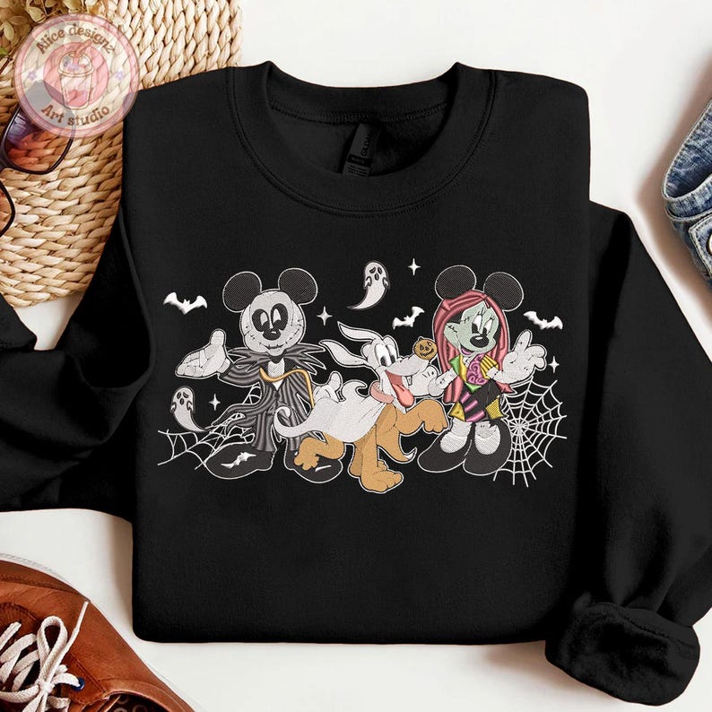 May include: Black sweatshirt featuring a Halloween-themed cartoon design. The graphic includes Mickey Mouse as Jack Skellington, Goofy as a ghost, and Minnie Mouse as a zombie. Bats, spiderwebs, and ghosts complete the spooky theme.
