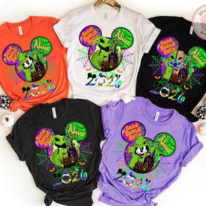 May include: Five colorful t-shirts with Halloween-themed designs. Each shirt features a Mickey Mouse head with a character, the words "Boogie Bash", and the year "2020". The shirts are orange, white, black, dark gray, and purple.