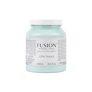 May include: A 16.9 fluid ounce bottle of Fusion Mineral Paint in the color Little Teapot. The paint is a light blue-green color. The bottle is labeled with the Fusion logo and the paint color name.
