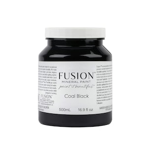 May include: A 16.9 fluid ounce bottle of Fusion Mineral Paint in the color Coal Black. The bottle is black with a white label and the Fusion logo. The label says "paint it beautiful".