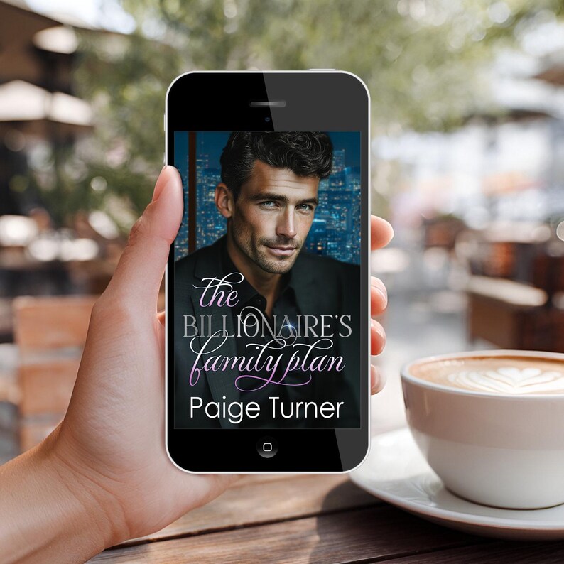 May include: A smartphone displays the cover of "The Billionaire's Family Plan" by Paige Turner. The cover features a man in a suit against a city skyline. A cup of coffee sits on a saucer in the foreground.