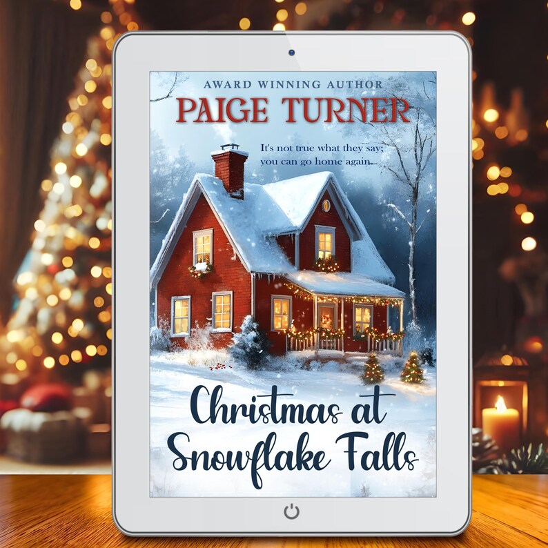 Puede incluir: Una tableta blanca mostrando la portada de un libro con una casa roja cubierta de nieve. La portada del libro tiene el t&iacute;tulo "Christmas at Snowflake Falls" y el nombre del autor "Paige Turner".