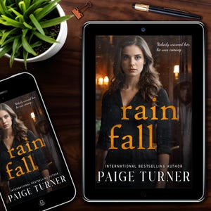 May include: A smartphone and tablet display the cover of the book "Rain Fall" by Paige Turner. The cover features a woman with long hair, the title in orange, and the tagline "Nobody warned her he was coming..."