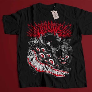 May include: Black t-shirt with a white and red graphic print of a creature with multiple eyes and sharp teeth. The creature is surrounded by a red and white flame-like design. The text "DECEIVER" is printed in white above the creature.