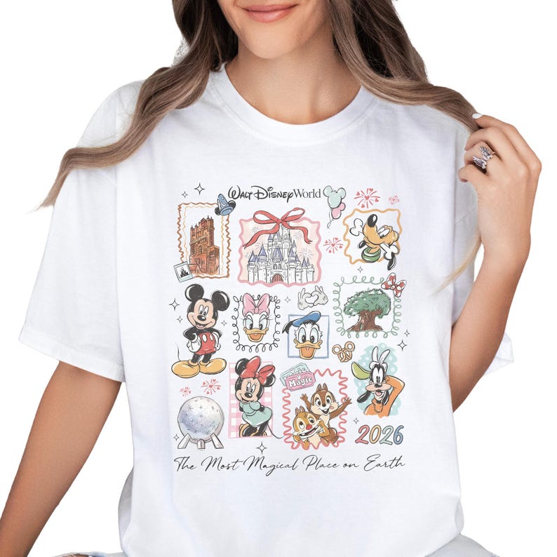 A white t-shirt with a collage of Disney characters and landmarks, including Mickey Mouse, Minnie Mouse, Donald Duck, Goofy, and a castle. The text on the t-shirt says "Disney World" and "The Most Magical Place on Earth".