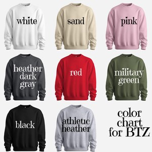 nine different sweatshirts, each with a unique color and text, arranged in a 3x3 grid.