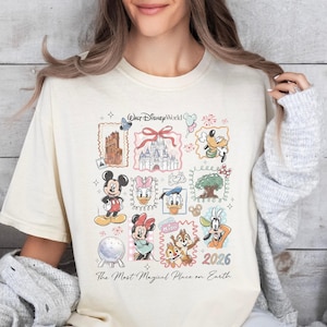 A woman wearing a white t-shirt with a collage of Disney characters and a text that says "The Most Magical Place on Earth" printed on it.