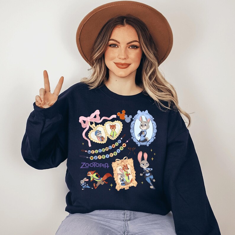A woman wearing a brown hat and a navy blue sweatshirt with various cartoon characters and designs, including a peace sign and a bunny.