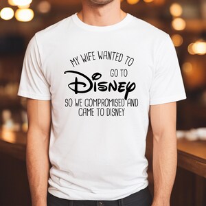 A man wearing a white t-shirt with a humorous text printed on it.