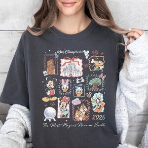A woman wearing a black t-shirt with a collage of Disney characters and the text "The Most Magical Place on Earth" printed on it.