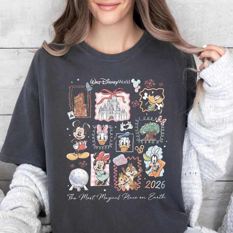 A woman wearing a black t-shirt with a collage of Disney characters and the text "The Most Magical Place on Earth" printed on it.