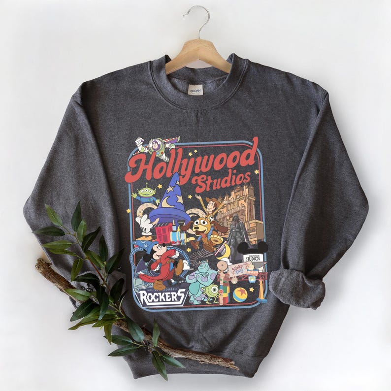 A gray sweatshirt with a graphic design featuring characters from the Disney Pixar film Toy Story, including characters like Woody, Buzz Lightyear, and a robot.