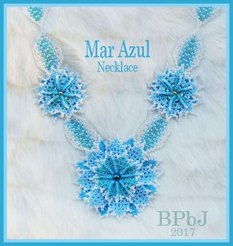 May include: A beaded necklace with a floral design. The necklace features light and dark blue beads with white accents. The text "Mar Azul Necklace" is displayed in the image. The necklace is set against a white background.