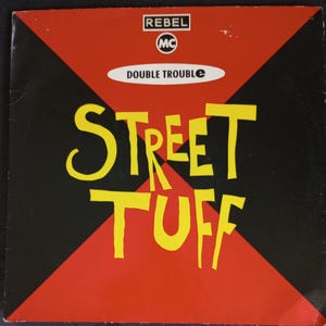 May include: A black and red record cover with a yellow title that reads "Street Tuff" and the text "Rebel MC Double Trouble" in a white rectangle.