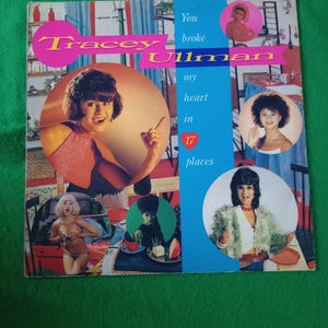 May include: A vintage vinyl record album cover featuring Tracey Ullman. The cover has a pink and yellow Tracey Ullman logo, with the text "You broke my heart in 17 places." The cover has several images of Tracey Ullman.