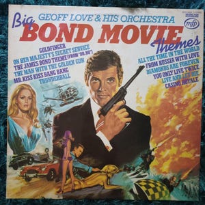 May include: Vintage vinyl record album cover for "Big Bond Movie Themes" by Geoff Love & His Orchestra. Features a man holding a gun, women, cars, and helicopters. Album titles include "Goldfinger" and "Casino Royale".