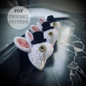 May include: A crochet pattern for a white bunny wearing a black top hat and a gold monocle. The pattern is available as a PDF download.