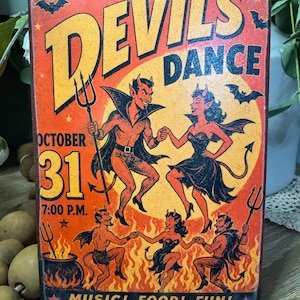 May include: A rectangular wooden sign with a vintage-style orange and yellow graphic featuring the text DEVILS DANCE, OCTOBER 31, 7:00 P.M., and MUSIC! FOOD! FUN! COSTUMES ENCOURAGED! The illustration depicts several red devils dancing over flames.