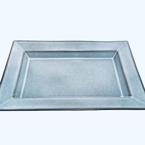 May include: A light blue rectangular ceramic serving tray with a raised rim.