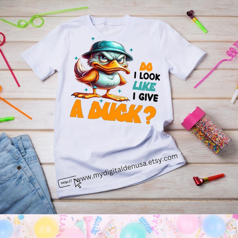 May include: White t-shirt with a cartoon duck wearing a hat and the text "Do I look like I give a duck?"