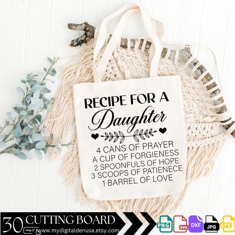 May include: A white tote bag with black text that reads "Recipe for a Daughter" and a list of ingredients for making a daughter, including "4 cans of prayer", "a cup of forgiveness", "2 spoonfuls of hope", "3 scoops of patience", and "1 barrel of love".