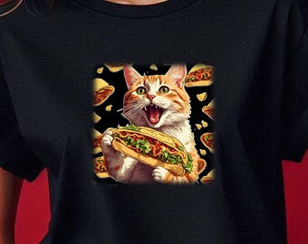 May include: A black t-shirt with a graphic of a cat eating a large taco. The cat is orange and white with green eyes. The taco is filled with lettuce, tomato, and cheese.