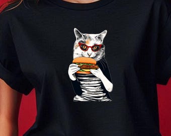 May include: Black t-shirt with a graphic of a cat wearing red glasses and holding a hamburger.