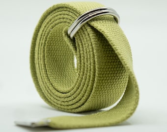 May include: A green canvas belt with a silver metal buckle. The belt is rolled up and the buckle is visible.