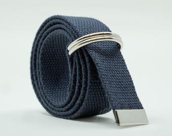 May include: A dark blue canvas belt with a silver metal buckle. The belt is rolled up and the buckle is visible.