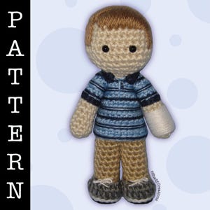 May include: Crocheted amigurumi doll with brown hair, a blue and white striped shirt, and brown pants. The doll has a white cast on its right arm.