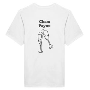 May include: A white short-sleeved t-shirt featuring a black line-art graphic of two champagne flutes clinking together. Above the glasses, the text "Cham Payne" is printed in a bold, dark, sans-serif font, positioned centrally on the back of the garment.
