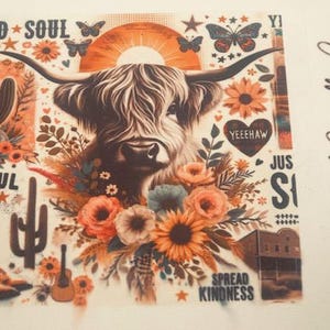 May include: A white background with a highland cow surrounded by flowers and a sunset. The text "WILD SOUL", "LOVE SOUL", "YEEEHAW", "JUS IS", and "SPREAD KINDNESS" is also on the image. The text "12th Street Candle Co." is on the right side of the image.